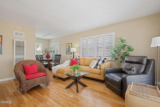 324 N J St, Oxnard, CA 93030 - living area featuring a heating unit, light wood finished floors, and track lighting