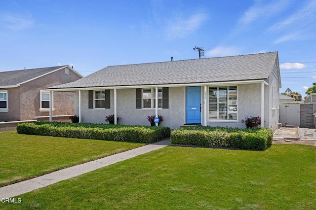 324 N J St, Oxnard, CA 93030 - view of front of home with stucco siding, a front lawn, and a shingled roof