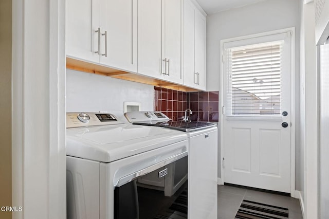 324 N J St, Oxnard, CA 93030 - washroom with cabinet space, washer and clothes dryer, and tile patterned floors