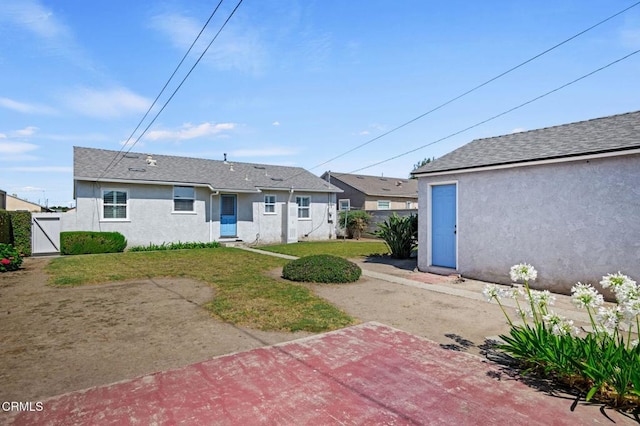 324 N J St, Oxnard, CA 93030 - back of house featuring stucco siding and a gate
