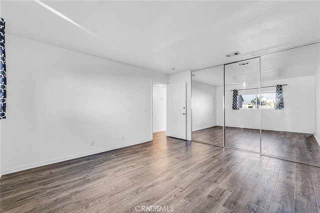 5224 Denny Ave Unit 209, North Hollywood, CA 91601 - unfurnished bedroom featuring wood finished floors and a closet