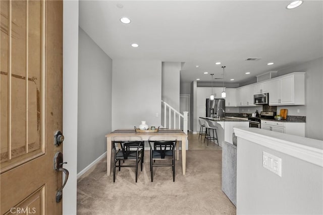 2894 E Via Fiano, Ontario, CA 91764 - dining room with light colored carpet, stairs, and recessed lighting