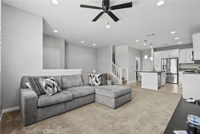 2894 E Via Fiano, Ontario, CA 91764 - living area featuring recessed lighting, stairs, ceiling fan, and light carpet