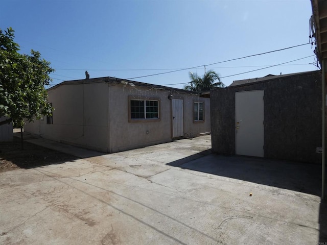 34850 Montgomery St, Chula Vista, CA 91911 - rear view of house featuring a patio area, an outbuilding, and stucco siding