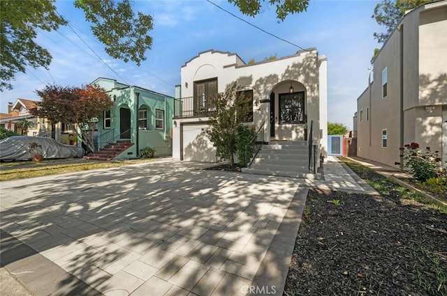 569 Lewis Ave, San Leandro, CA 94577 - view of front of property with stairs, concrete driveway, stucco siding, and a garage