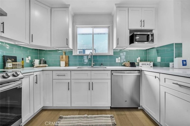 569 Lewis Ave, San Leandro, CA 94577 - kitchen featuring stainless steel appliances, light wood-style floors, light countertops, and white cabinets