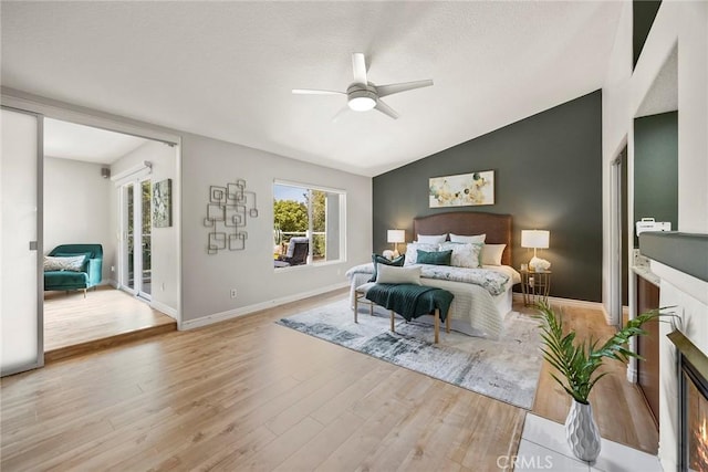5210 Avenida De Kristine, Yorba Linda, CA 92887 - bedroom featuring vaulted ceiling, wood finished floors, a glass covered fireplace, a textured ceiling, and ceiling fan