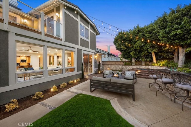 5210 Avenida De Kristine, Yorba Linda, CA 92887 - back of house featuring stucco siding, an outdoor living space with a fire pit, and a patio