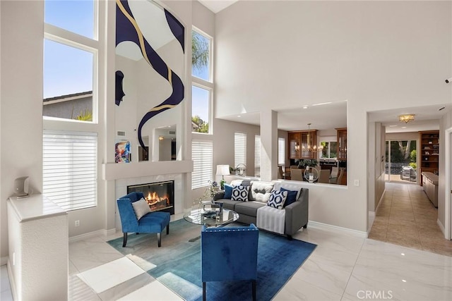 5210 Avenida De Kristine, Yorba Linda, CA 92887 - living room featuring marble finish flooring, a high ceiling, a fireplace, and healthy amount of natural light