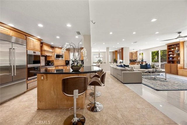 5210 Avenida De Kristine, Yorba Linda, CA 92887 - kitchen featuring built in appliances, recessed lighting, a breakfast bar area, dark countertops, and premium range hood