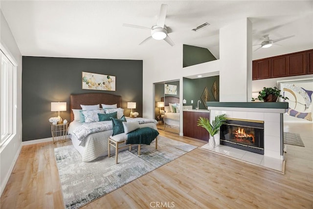 5210 Avenida De Kristine, Yorba Linda, CA 92887 - bedroom featuring light wood-style flooring, an accent wall, a fireplace, lofted ceiling, and ceiling fan
