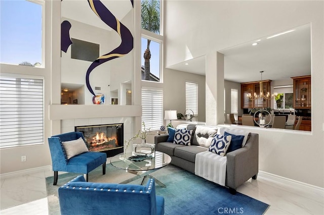 5210 Avenida De Kristine, Yorba Linda, CA 92887 - living room featuring marble look tiles, a tiled fireplace, a chandelier, plenty of natural light, and a towering ceiling