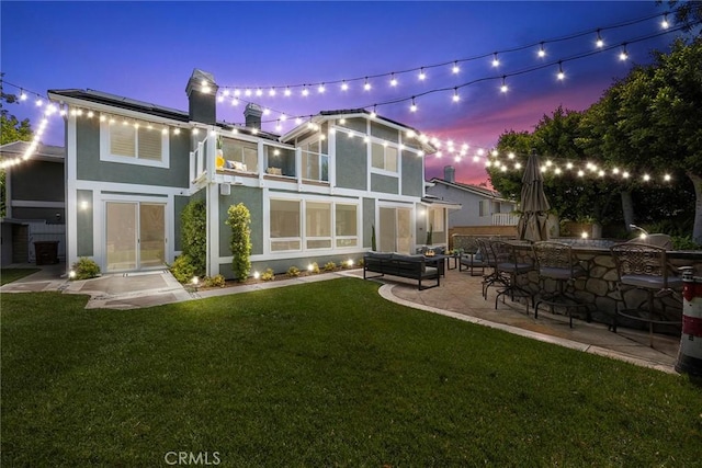 5210 Avenida De Kristine, Yorba Linda, CA 92887 - back of house featuring stucco siding, a lawn, a patio area, and roof mounted solar panels