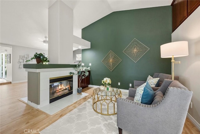 5210 Avenida De Kristine, Yorba Linda, CA 92887 - living room with light wood finished floors, ceiling fan, a tiled fireplace, and high vaulted ceiling