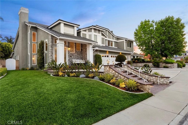5210 Avenida De Kristine, Yorba Linda, CA 92887 - view of front facade with stone siding, an attached garage, driveway, and a front lawn