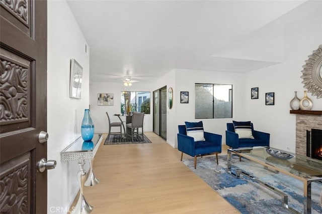 371 N Melrose Dr Unit A, Vista, CA 92083 - living area featuring wood finished floors, a fireplace, and a ceiling fan