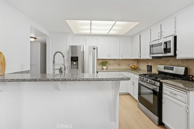 371 N Melrose Dr Unit A, Vista, CA 92083 - kitchen with appliances with stainless steel finishes, light stone countertops, and white cabinets
