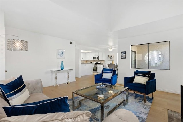 371 N Melrose Dr Unit A, Vista, CA 92083 - living room with light wood finished floors and a ceiling fan