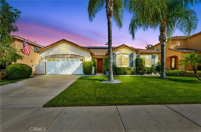 33818 Channel St, Temecula, CA 92592 - mediterranean / spanish-style house with a garage, stucco siding, driveway, solar panels, and a front yard