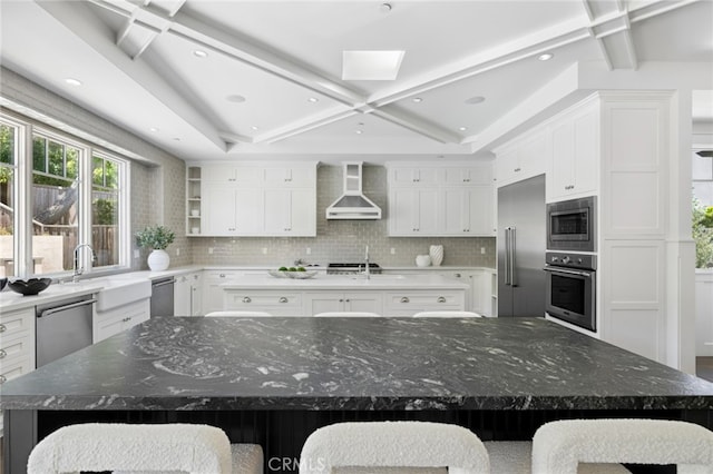 1456 Key Vw, Corona Del Mar, CA 92625 - kitchen with appliances with stainless steel finishes, wall chimney exhaust hood, a large island, decorative backsplash, and beam ceiling
