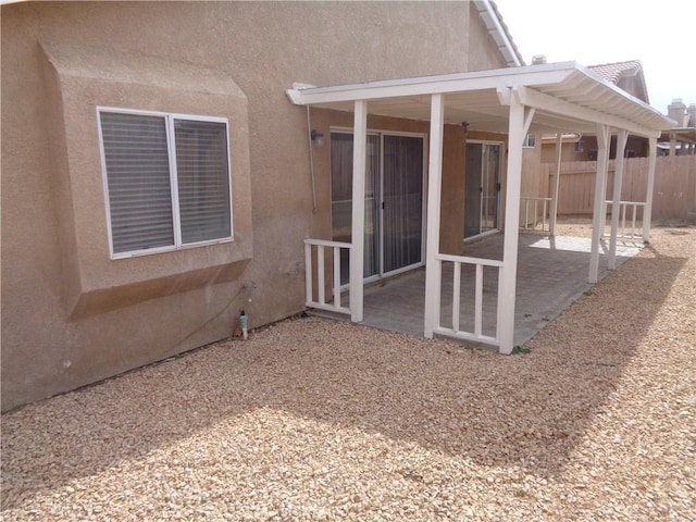 2425 Dixie St, Rosamond, CA 93560 - back of house with stucco siding and a patio area