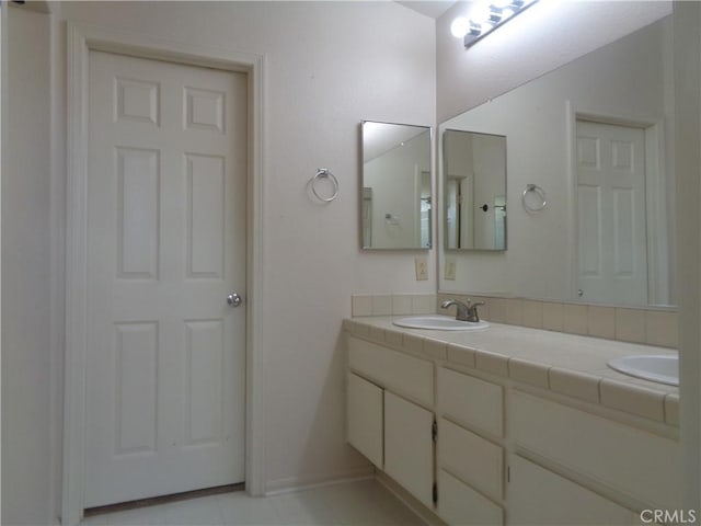 2425 Dixie St, Rosamond, CA 93560 - bathroom featuring double vanity and baseboards