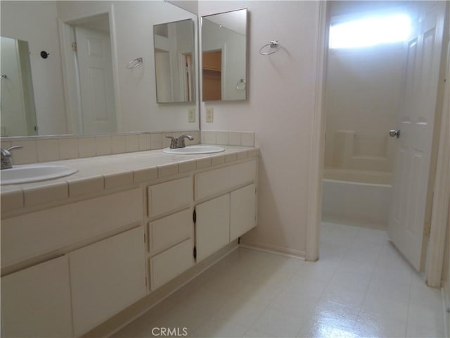 2425 Dixie St, Rosamond, CA 93560 - bathroom with double vanity and shower / washtub combination