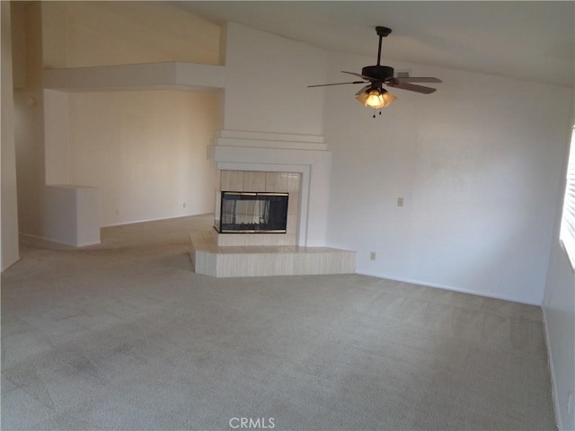 2425 Dixie St, Rosamond, CA 93560 - unfurnished living room featuring carpet flooring, a tiled fireplace, ceiling fan, and high vaulted ceiling