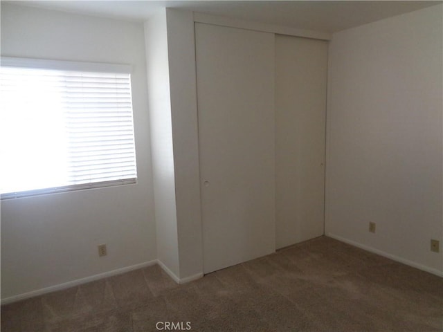 2425 Dixie St, Rosamond, CA 93560 - unfurnished bedroom featuring light colored carpet and a closet