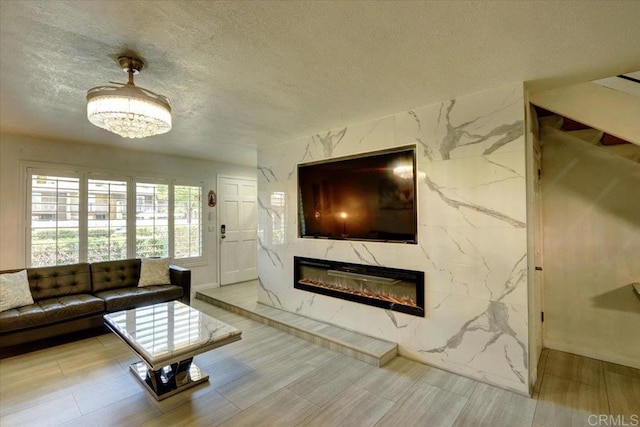 990 E Main St Unit A, El Cajon, CA 92021 - living area featuring a high end fireplace, a textured ceiling, and wood finished floors