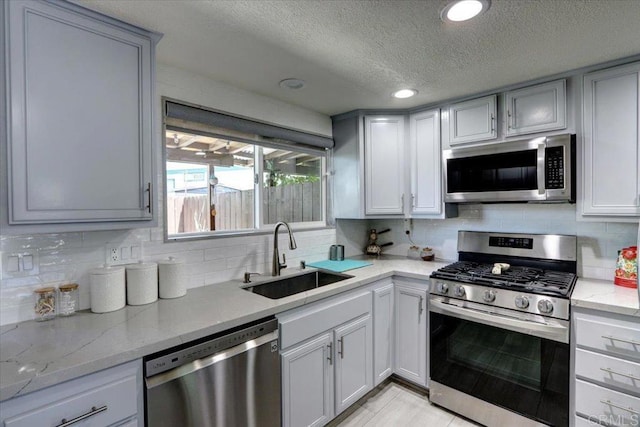 990 E Main St Unit A, El Cajon, CA 92021 - kitchen featuring stainless steel appliances, a textured ceiling, tasteful backsplash, light stone counters, and recessed lighting