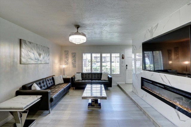 990 E Main St Unit A, El Cajon, CA 92021 - living area featuring a textured ceiling and a fireplace