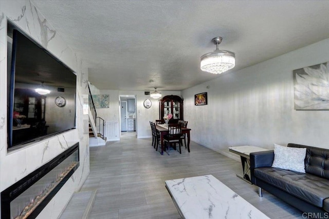 990 E Main St Unit A, El Cajon, CA 92021 - living area featuring stairway, a textured ceiling, and wood finished floors
