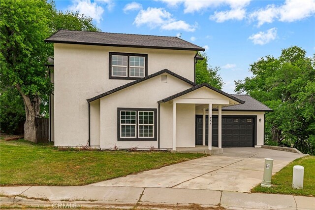 255 Sparrow Ct, Red Bluff, CA 96080 - traditional-style home featuring concrete driveway, an attached garage, a front lawn, and stucco siding