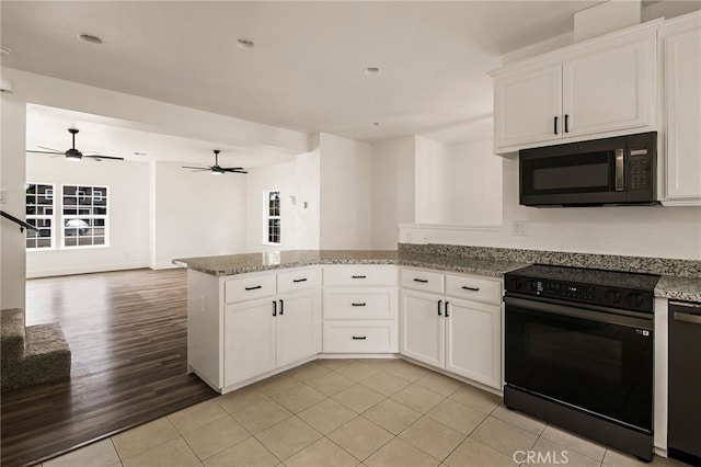 255 Sparrow Ct, Red Bluff, CA 96080 - kitchen featuring black / electric stove, a peninsula, light tile patterned floors, white cabinetry, and open floor plan