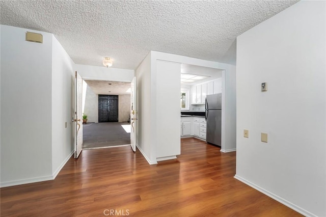 2385 Via Mariposa Unit 1F, Laguna Woods, CA 92637 - interior space featuring dark wood-style floors and a textured ceiling