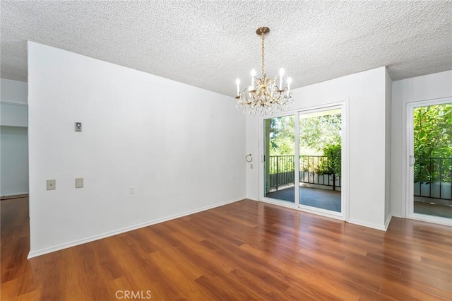 2385 Via Mariposa Unit 1F, Laguna Woods, CA 92637 - spare room with wood finished floors, a chandelier, and a textured ceiling