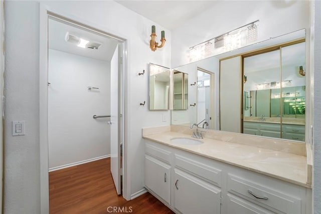 2385 Via Mariposa Unit 1F, Laguna Woods, CA 92637 - bathroom featuring wood finished floors and vanity