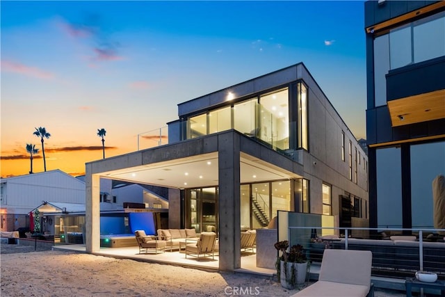 35411 Beach Rd, Dana Point, CA 92624 - back of property at dusk with outdoor lounge area, stairs, and a patio area