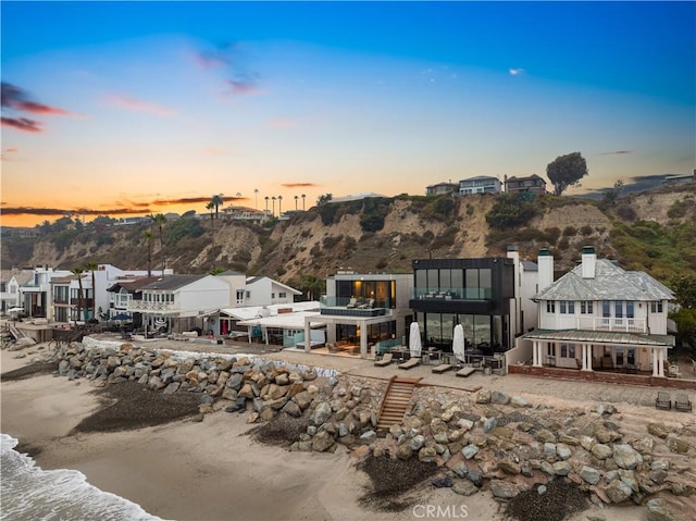35411 Beach Rd, Dana Point, CA 92624 - back of house at dusk featuring a patio area, a mountain view, a balcony, and a residential view