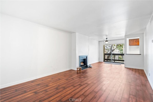8210 Summertime Ln Unit 210, Culver City, CA 90230 - unfurnished living room featuring dark wood-type flooring, a lit fireplace, and a ceiling fan