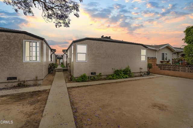 136 N Garfield Ave, Oxnard, CA 93030 - property exterior at dusk with crawl space and stucco siding