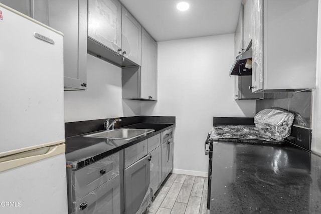 136 N Garfield Ave, Oxnard, CA 93030 - kitchen with freestanding refrigerator, light wood-style floors, gray cabinetry, and under cabinet range hood