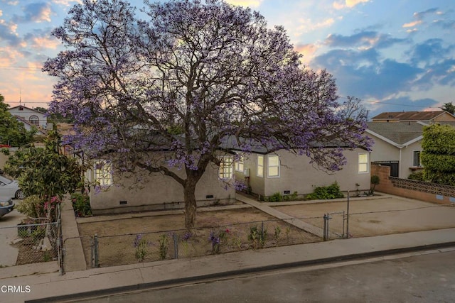 136 N Garfield Ave, Oxnard, CA 93030 - view of property hidden behind natural elements with a fenced front yard and stucco siding