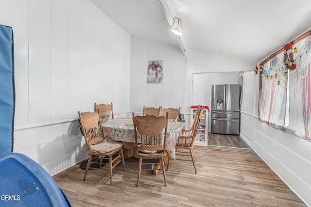 136 N Garfield Ave, Oxnard, CA 93030 - dining area with lofted ceiling, wood finished floors, and a decorative wall