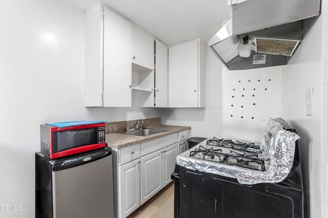 136 N Garfield Ave, Oxnard, CA 93030 - kitchen featuring range hood, refrigerator, white cabinets, open shelves, and light wood-style flooring