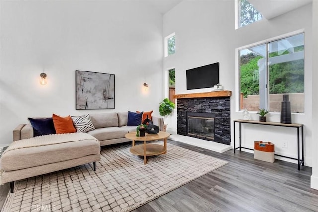 37 Conch Reef, Aliso Viejo, CA 92656 - living room with healthy amount of natural light, wood finished floors, a fireplace, and a high ceiling