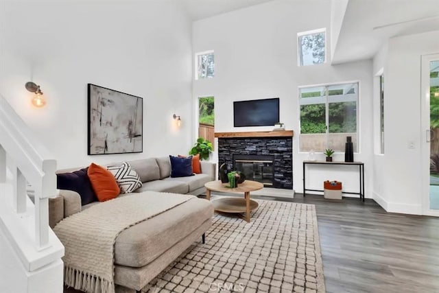 37 Conch Reef, Aliso Viejo, CA 92656 - living area with wood finished floors, a stone fireplace, and a towering ceiling