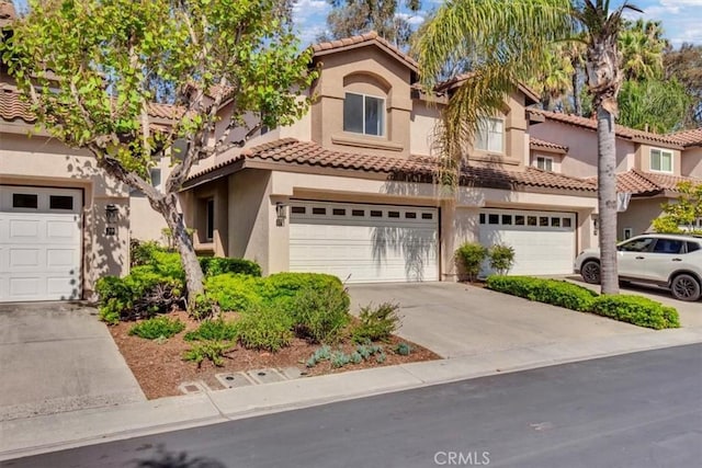 37 Conch Reef, Aliso Viejo, CA 92656 - view of front facade featuring stucco siding, a tiled roof, concrete driveway, and a garage
