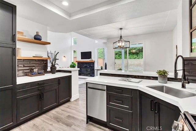 37 Conch Reef, Aliso Viejo, CA 92656 - kitchen featuring light countertops, light wood-style flooring, recessed lighting, a chandelier, and a fireplace